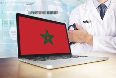 Fas teknoloji tema sağlık sisteminde. Fas bayrak bilgisayar ekranında. Hastanede stetoskop ile ayakta doktor. Cryptocurrency ve Blockchain kavramı.