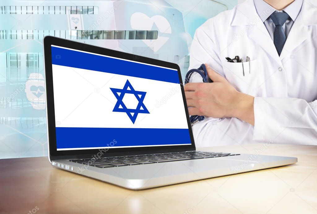 Israel healthcare system in tech theme. Israeli flag on computer screen. Doctor standing with stethoscope in hospital. Cryptocurrency and Blockchain concept.