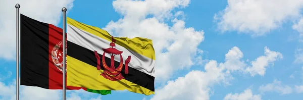Afeganistão e Brunei acenando com o vento contra o céu azul nublado branco juntos. Conceito de diplomacia, relações internacionais . — Fotografia de Stock
