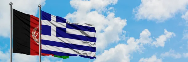 阿富汗和希腊国旗在风中飘扬，白云蓝天相拥。外交概念、国际关系. — 图库照片