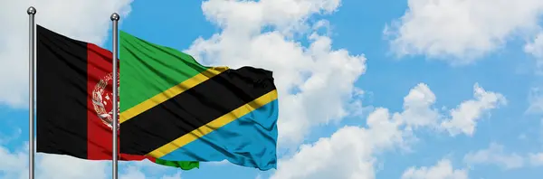 Afghanistan and Tanzania flag waving in the wind against white cloudy blue sky together. Diplomacy concept, international relations. — Stock Photo, Image