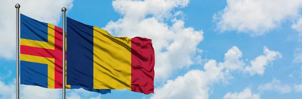 Aland Islands and Chad flag waving in the wind against white cloudy blue sky together. Diplomacy concept, international relations. — Stock Photo, Image