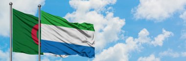 Cezayir ve Sierra Leone bayrağı birlikte beyaz bulutlu mavi gökyüzüne karşı rüzgarda sallayarak. Diplomasi kavramı, uluslararası ilişkiler.