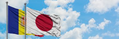 Andorra ve Japonya bayrağı birlikte beyaz bulutlu mavi gökyüzüne karşı rüzgarda sallayarak. Diplomasi kavramı, uluslararası ilişkiler.
