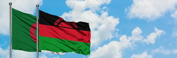 Algeria and Malawi flag waving in the wind against white cloudy blue sky together. Diplomacy concept, international relations. — Stock Photo, Image