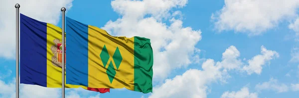 Andorra and Saint Vincent And The Grenadines flag waving in the wind against white cloudy blue sky together. Diplomacy concept, international relations. — Stock Photo, Image
