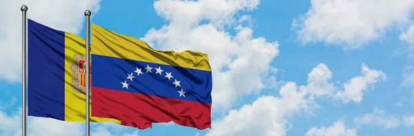 Андорра і Венесуела прапор розмахуючи на вітрі проти білого хмарного синього неба разом. Концепція дипломатії, міжнародні відносини. — стокове фото