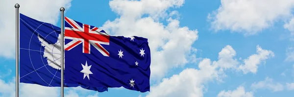 Bandera de la Antártida y Australia ondeando en el viento contra el cielo azul nublado blanco juntos. Concepto diplomático, relaciones internacionales . — Foto de Stock