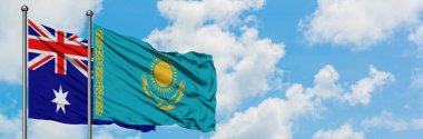Avustralya ve Kazakistan bayrağı birlikte beyaz bulutlu mavi gökyüzüne karşı rüzgarsal sallayarak. Diplomasi kavramı, uluslararası ilişkiler.