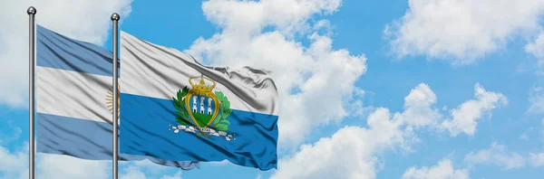 Argentina and San Marino flag waving in the wind against white cloudy blue sky together. Diplomacy concept, international relations. — Stock Photo, Image