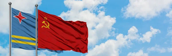 Aruba and Soviet Union flag waving in the wind against white cloudy blue sky together. Diplomacy concept, international relations. — Stock Photo, Image