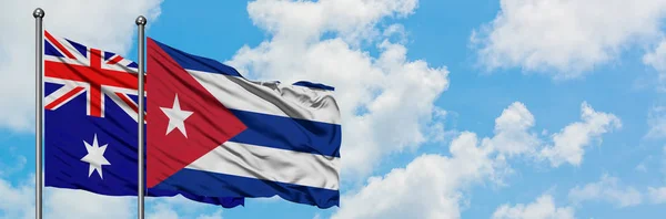 澳大利亚和古巴国旗在风中飘扬，白云蓝天相聚。外交概念、国际关系. — 图库照片