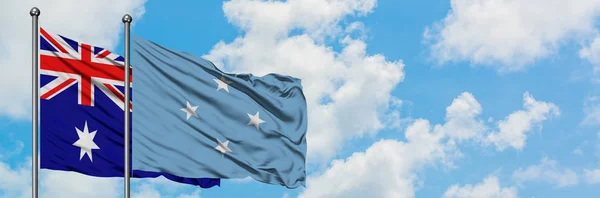 Ausztrália és a Mikronéziai zászló integetett a szél ellen, fehér felhős kék ég együtt. Diplomáciai koncepció, nemzetközi kapcsolatok. — Stock Fotó