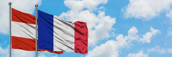 Austria and France flag waving in the wind against white cloudy blue sky together. Diplomacy concept, international relations. — Stock Photo, Image