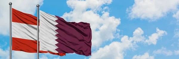 Austria and Qatar flag waving in the wind against white cloudy blue sky together. Diplomacy concept, international relations. — Stock Photo, Image