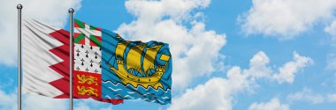 Bahreyn ve Saint Pierre ve Miquelon bayrağı birlikte beyaz bulutlu mavi gökyüzüne karşı rüzgarda sallayarak. Diplomasi kavramı, uluslararası ilişkiler.