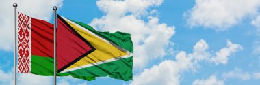 Beyaz Rusya ve Guyana bayrağı birlikte beyaz bulutlu mavi gökyüzüne karşı rüzgarda sallayarak. Diplomasi kavramı, uluslararası ilişkiler.