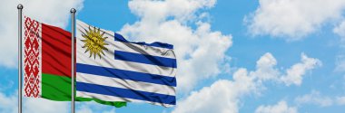 Beyaz Rusya ve Uruguay bayrağı birlikte beyaz bulutlu mavi gökyüzüne karşı rüzgarsal sallayarak. Diplomasi kavramı, uluslararası ilişkiler.