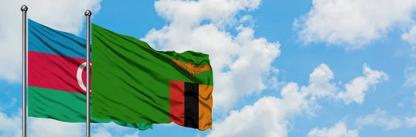 Bandera de Azerbaiyán y Zambia ondeando en el viento contra el cielo azul nublado blanco juntos. Concepto diplomático, relaciones internacionales . — Foto de Stock