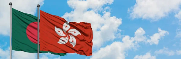 Bandera de Bangladesh y Hong Kong ondeando en el viento contra el cielo azul nublado blanco juntos. Concepto diplomático, relaciones internacionales . — Foto de Stock