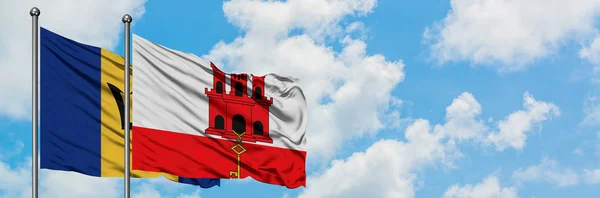 Barbados and Gibraltar flag waving in the wind against white cloudy blue sky together. Diplomacy concept, international relations. — Stock Photo, Image