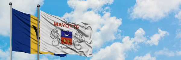 Drapeau de la Barbade et de Mayotte agitant dans le vent contre ciel bleu nuageux blanc ensemble. Concept de diplomatie, relations internationales . — Photo