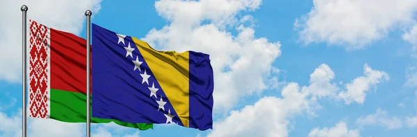 Belarus and Bosnia Herzegovina flag waving in the wind against white cloudy blue sky together. Diplomacy concept, international relations. — Stock Photo, Image