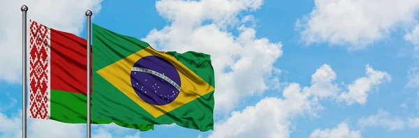 Belarus and Brazil flag waving in the wind against white cloudy blue sky together. Diplomacy concept, international relations.