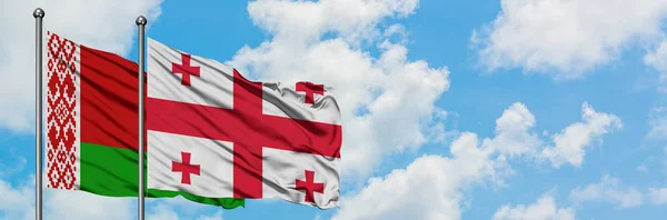 Belarus and Georgia flag waving in the wind against white cloudy blue sky together. Diplomacy concept, international relations. — Stock Photo, Image