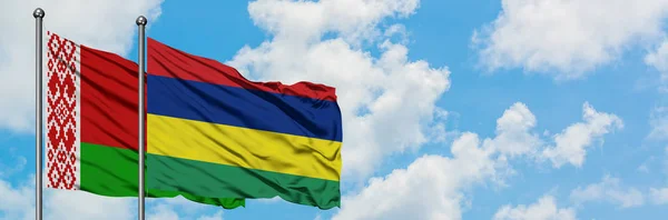 Bandera de Bielorrusia y Mauricio ondeando en el viento contra el cielo azul nublado blanco juntos. Concepto diplomático, relaciones internacionales . — Foto de Stock