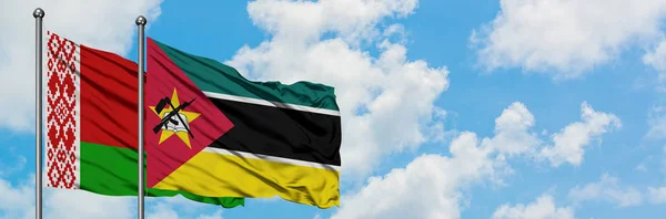 Belarus and Mozambique flag waving in the wind against white cloudy blue sky together. Diplomacy concept, international relations. — Stock Photo, Image