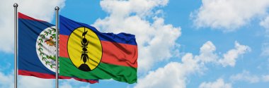 Belize ve Yeni Kaledonya bayrağı birlikte beyaz bulutlu mavi gökyüzüne karşı rüzgarda sallayarak. Diplomasi kavramı, uluslararası ilişkiler.