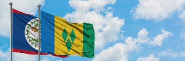 Belize ve Saint Vincent ve Grenadinler bayrak birlikte beyaz bulutlu mavi gökyüzüne karşı rüzgarda sallayarak. Diplomasi kavramı, uluslararası ilişkiler.
