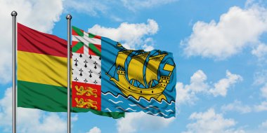 Bolivya ve Saint Pierre ve Miquelon bayrağı birlikte beyaz bulutlu mavi gökyüzüne karşı rüzgarda sallayarak. Diplomasi kavramı, uluslararası ilişkiler.