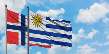 Bouvet Adaları ve Uruguay bayrağı birlikte beyaz bulutlu mavi gökyüzüne karşı rüzgarda sallayarak. Diplomasi kavramı, uluslararası ilişkiler.