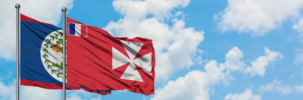 Glaube und Wallis und Futuna-Flagge wehen gemeinsam im Wind vor weißem wolkenblauem Himmel. Diplomatie-Konzept, internationale Beziehungen. — Stockfoto