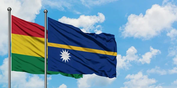 Bolivia and Nauru flag waving in the wind against white cloudy blue sky together. Diplomacy concept, international relations. — Stock Photo, Image