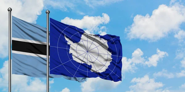 Botswana and Antarctica flag waving in the wind against white cloudy blue sky together. Diplomacy concept, international relations. — Stock Photo, Image