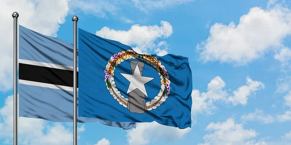 Botswana and Northern Mariana Islands flag waving in the wind against white cloudy blue sky together. Diplomacy concept, international relations. — Stock Photo, Image