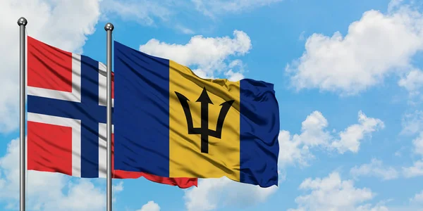 Bandera de las Islas Bouvet y Barbados ondeando en el viento contra el cielo azul nublado blanco juntos. Concepto diplomático, relaciones internacionales . — Foto de Stock