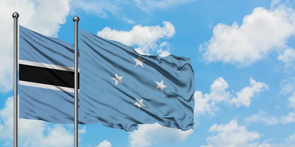 Botswana and Micronesia flag waving in the wind against white cloudy blue sky together. Diplomacy concept, international relations. — Stock Photo, Image