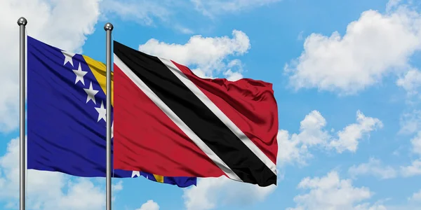 Bosna Hersek ve Trinidad ve Tobago bayrağı birlikte beyaz bulutlu mavi gökyüzüne karşı rüzgarda sallayarak. Diplomasi kavramı, uluslararası ilişkiler. — Stok fotoğraf