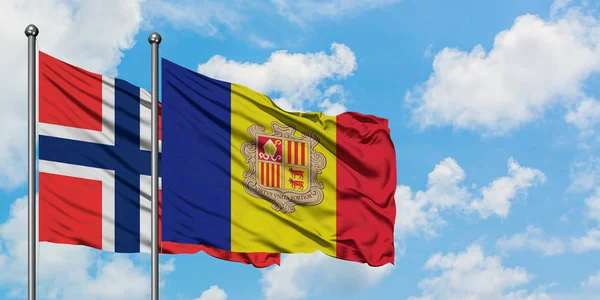 Bandera de las Islas Bouvet y Andorra ondeando en el viento contra el cielo azul nublado blanco juntos. Concepto diplomático, relaciones internacionales . — Foto de Stock