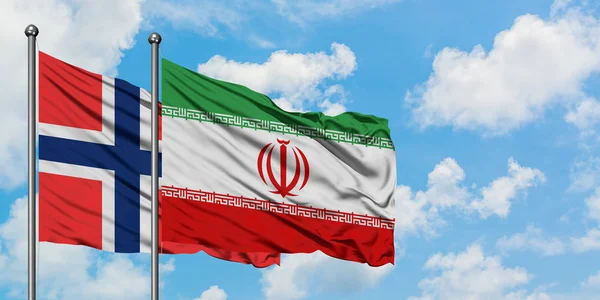 Bandera de las Islas Bouvet e Irán ondeando en el viento contra el cielo azul nublado blanco juntos. Concepto diplomático, relaciones internacionales . — Foto de Stock