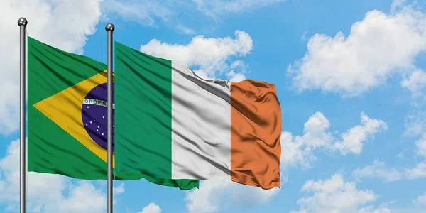 Brazil and Ireland flag waving in the wind against white cloudy blue sky together. Diplomacy concept, international relations. — Stock Photo, Image