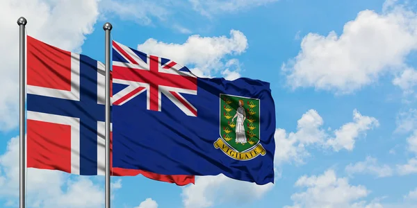 Bouvet eilanden en Britse Maagdeneilanden vlag zwaaien in de wind tegen witte bewolkte blauwe hemel samen. Diplomatie concept, internationale betrekkingen. — Stockfoto