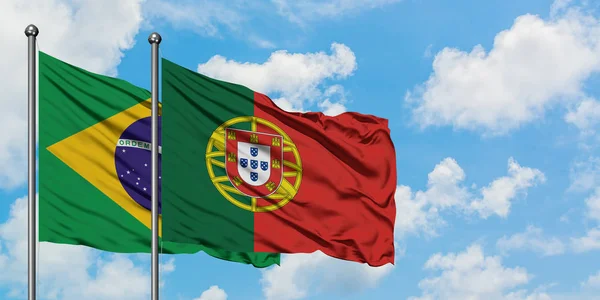 Brasile e Portogallo sventolano insieme la bandiera contro il bianco cielo blu nuvoloso. Concetto di diplomazia, relazioni internazionali . — Foto Stock