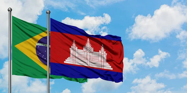 Brazil and Cambodia flag waving in the wind against white cloudy blue sky together. Diplomacy concept, international relations. — Stock Photo, Image