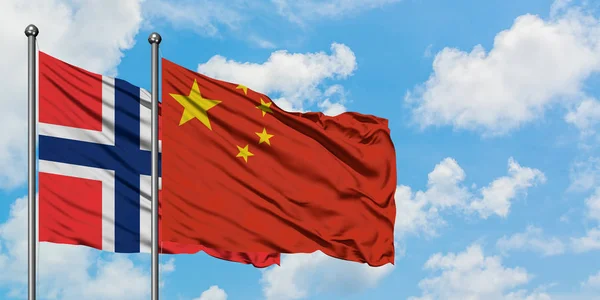 Bandera de las islas Bouvet y China ondeando en el viento contra el cielo azul nublado blanco juntos. Concepto diplomático, relaciones internacionales . — Foto de Stock