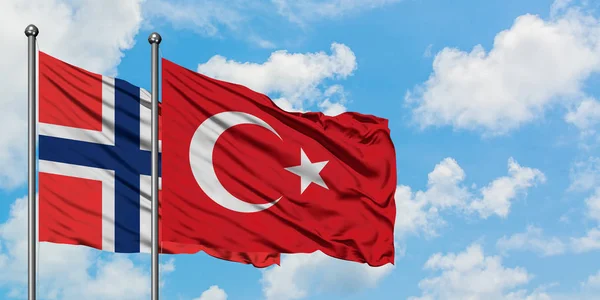 Bandera de las islas Bouvet y Turquía ondeando en el viento contra el cielo azul nublado blanco juntos. Concepto diplomático, relaciones internacionales . — Foto de Stock